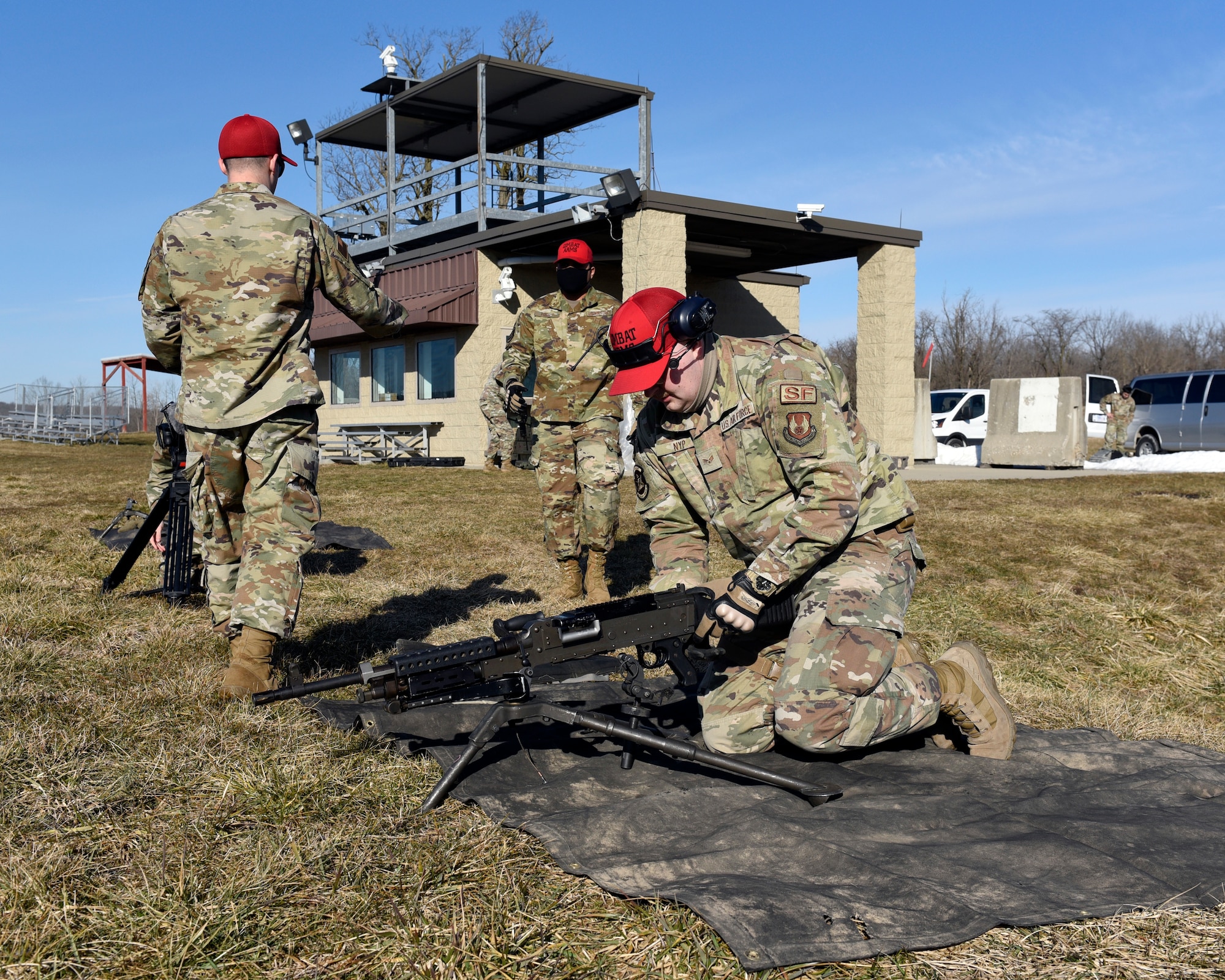 Air Force combat arms instructors with the 88th Security Forces Squadron assemble an M240B machine gun on a shooting range at Camp Atterbury in Edinburgh, Indiana, on Feb. 25, 2021. The combat arms instructors, from Wright-Patterson Air Force Base, Ohio, travel to Camp Atterbury multiple times each year for readiness and qualification training with deployers on machine guns and grenade launchers. (U.S. Air Force photo by Ty Greenlees)