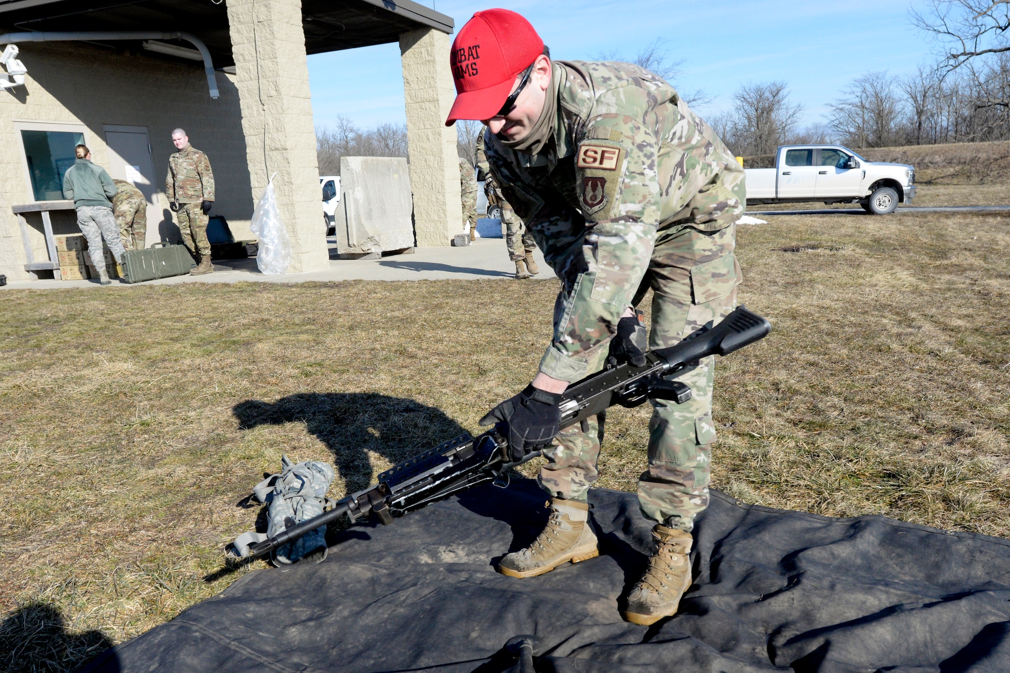 Air Force Staff Sgt. Sawyer McIntyre, an 88th Security Forces Squadron combat arms instructor, carries an M240B machine gun to a shooting range at Camp Atterbury in Edinburgh, Indiana, on Feb. 25, 2021. The 88th SFS combat arms instructors, from Wright-Patterson Air Force Base, Ohio, travel to Camp Atterbury multiple times each year for readiness and qualification training with deployers on machine guns and grenade launchers. (U.S. Air Force photo by Ty Greenlees)