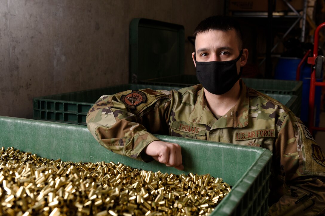 Air Force Technical Sgt. Richard Thomas, the 88 Security Forces Squadron noncommissioned officer in charge of Combat Arms, with a container full of spent bullet casings from the indoor range at Wright-Patterson Air Force Base, Ohio, on Feb. 17, 2021. Thomas and his team of combat arms instructors work to keep personnel in the 88th Air Base Wing weapons qualified for readiness and deployment requirements. (U.S. Air Force photo by Ty Greenlees)