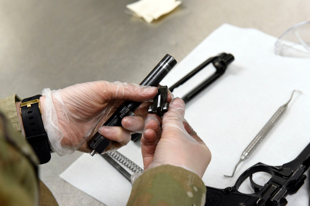 Air Force 2nd Lt. Mariah Armstrong, an 88th Medical Group critical care nurse, cleans her M9 pistol after qualifying at the 88th Security Forces Squadron Combat Arms firing range at Wright-Patterson Air Force Base, Ohio on Feb. 18, 2021. Weapons qualification is part of the readiness standards for the 88th Air Base Wing. (U.S. Air Force photo by Ty Greenlees)