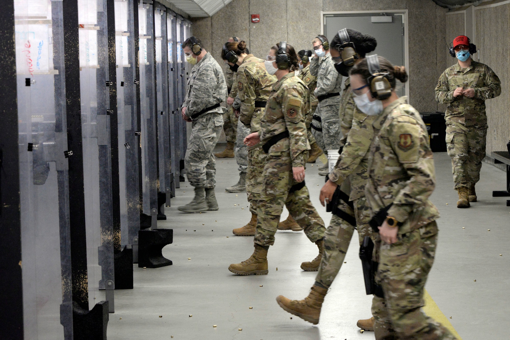 Air Force personnel with the 88th Medical Group step to the firing line inside the 88th Security Forces Squadron Combat Arms firing range at Wright-Patterson Air Force Base, Ohio on Feb. 18, 2021. The Airmen were qualifying with the M9 pistol as part of the readiness standards for the 88th Air Base Wing. (U.S. Air Force photo by Ty Greenlees)