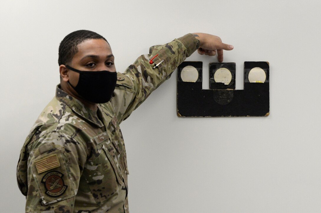 Air Force Senior Airman Jerome Fogg, an 88th Security Forces Squadron combat arms instructor, teaches sighting for the M9 pistol during a qualification course at Wright-Patterson Air Force Base, Ohio on Feb. 18, 2021. Weapons qualification is part of the readiness standards for the 88th Air Base Wing. No live ammunition is allowed in the classroom portion of the qualification course. (U.S. Air Force photo by Ty Greenlees)