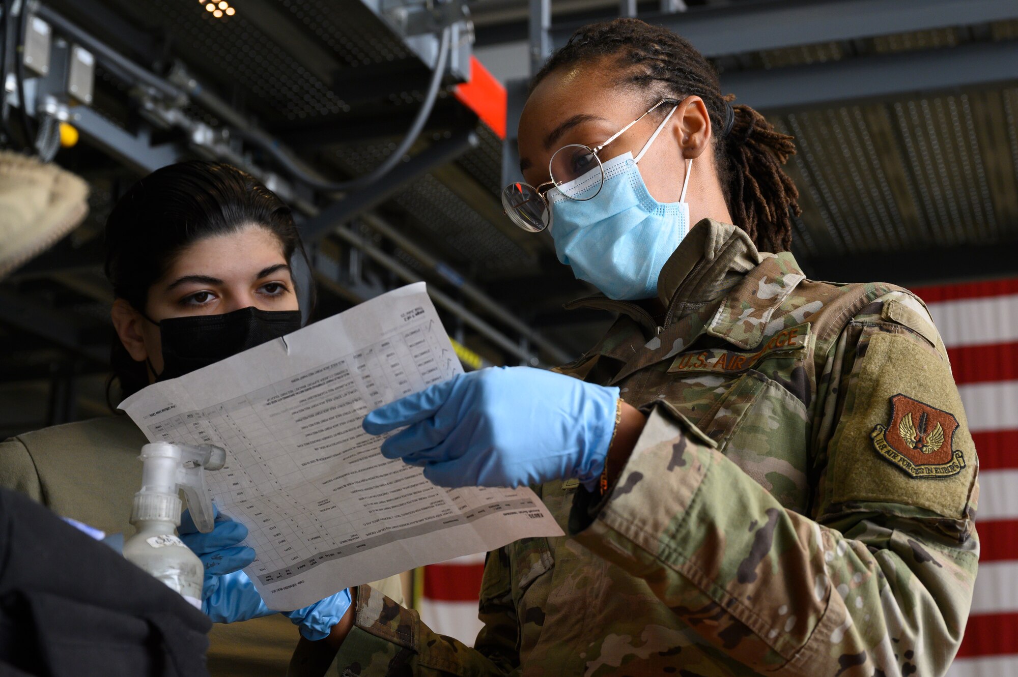 An Airman goes over a checklist with another Airman.