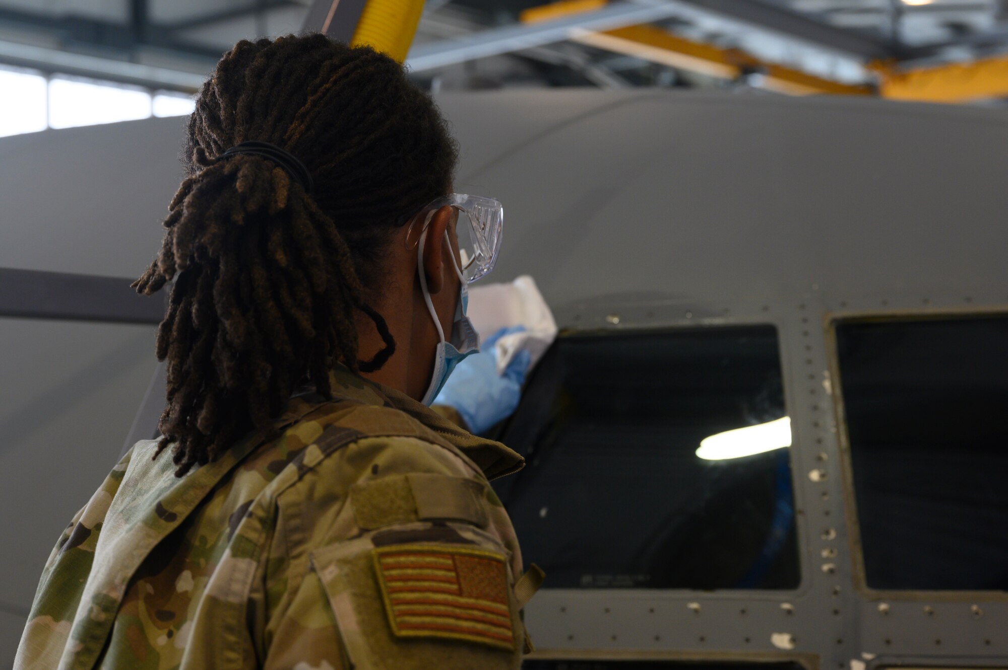 An Airman applies rubbing alcohol to a C-130J.