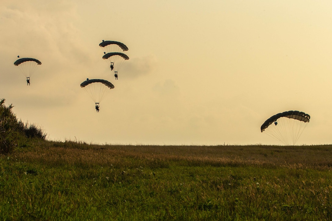 U.S. Marines with 3d Reconnaissance Battalion, 3d Marine Division conduct a military freefall infiltration during Castaway 21.1 on Ie Shima, Okinawa, Japan, March 9, 2021. The exercise demonstrated the Marine Corps’ ability to integrate with the joint force to seize and defend key maritime terrain, provide low-signature sustainment, and execute long-range precision fires in support of naval operations from an expeditionary advanced base. (U.S. Marine Corps photo by Lance Cpl. Scott Aubuchon)