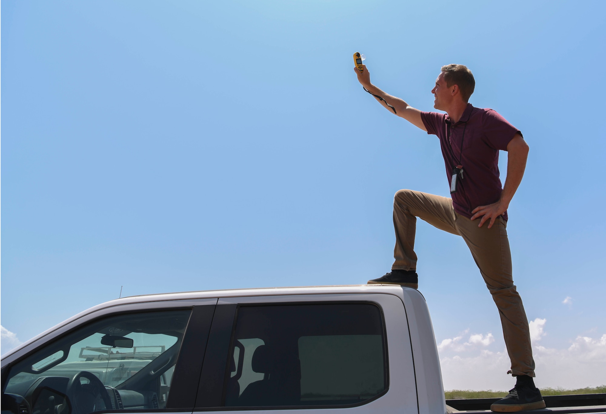 A U.S. Air Force member assigned to the 82nd Expeditionary Air Base Squadron, checks the wind prior to a jump at Camp Lemonnier, Djibouti, March 16, 2021.