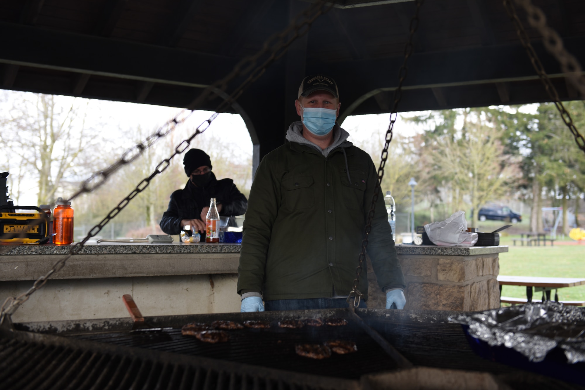 A volunteer cooks burgers for the Air Force Assistance Fund’s Kick-off Campaign event on Spangdahlem Air Base, Germany, March 13, 2021.
