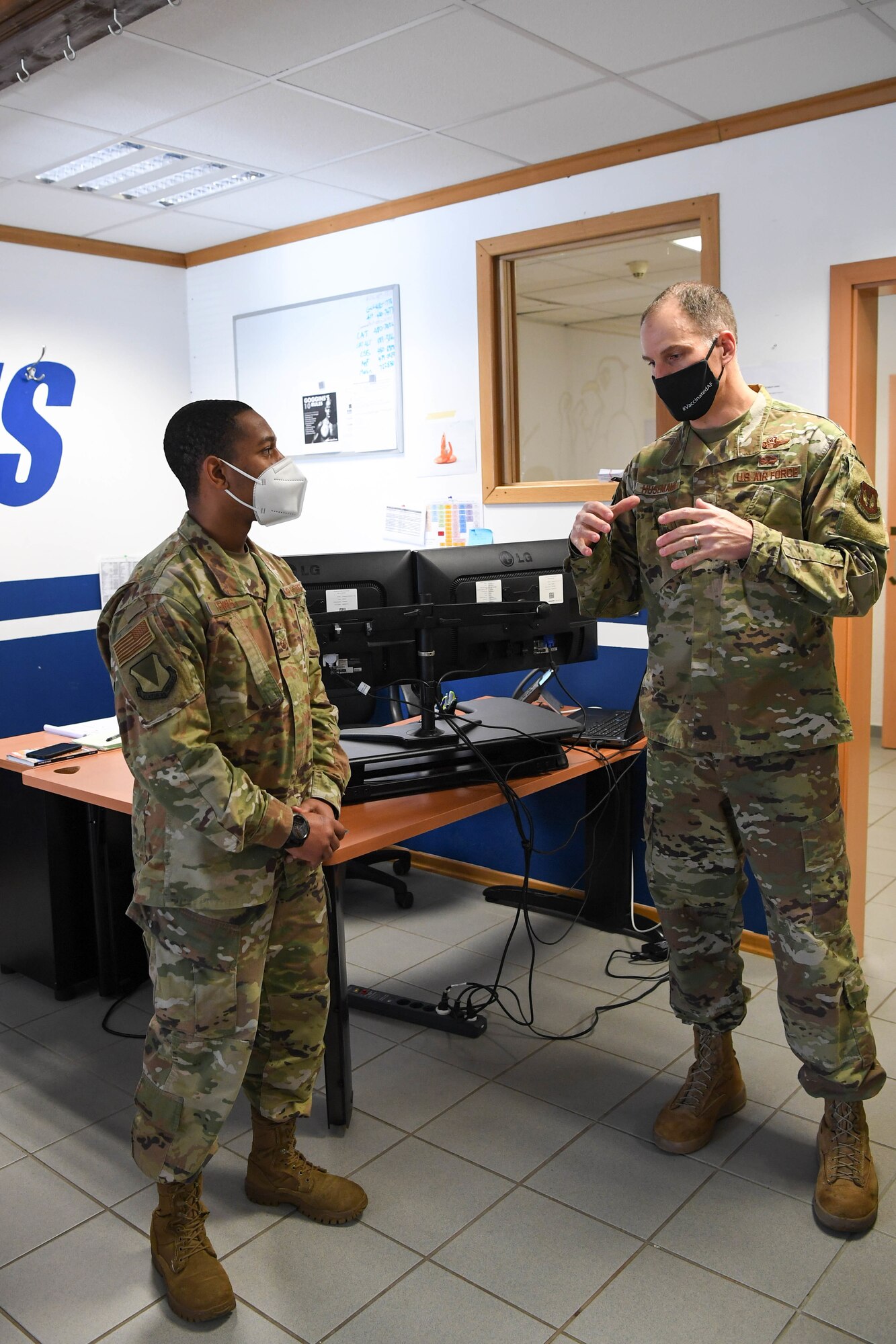 Two Airmen talking