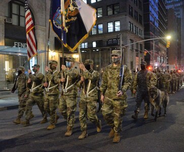 Soldiers of the New York Army National Guard's 1st Battalion, 69th Infantry, step off for an abbreviated version of the annual St. Patrick's Day Parade accompanied by Irish Wolfhounds, the traditional mascot of the regiment, in New York March 17, 2021. The regiment has led the parade annually since 1851.