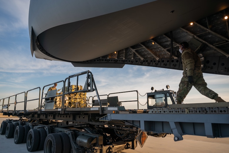 Cargo specialists from the 436th Aerial Port Squadron prepare to load cargo onto a Royal Australian Air Force C-17 Globemaster III at Dover Air Force Base, Delaware, March 13, 2021. The U.S. and Australia maintain a robust relationship underpinned by shared democratic values, common interests and cultural bonds. The U.S.-Australia alliance is an anchor for peace and stability in the Indo-Pacific region and around the world. (U.S. Air Force photo by Airman 1st Class Faith Schaefer)
