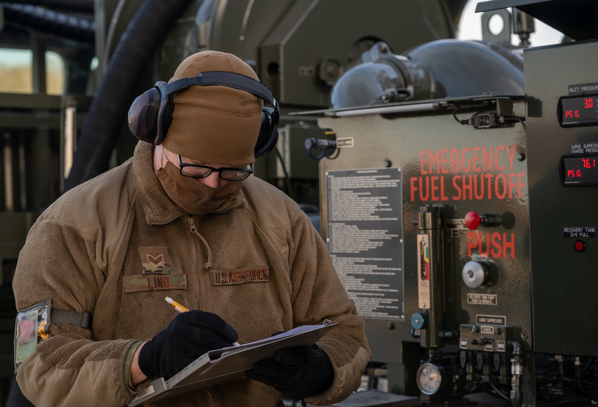Senior Airman Patrick Lind, 436th Logistics Readiness Squadron fuels journeyman, marks a checklist while fueling a Royal Australian Air Force C-17 Globemaster III at Dover Air Force Base, Delaware, March 13, 2021. The U.S. and Australia maintain a robust relationship underpinned by shared democratic values, common interests and cultural bonds. The U.S.-Australia alliance is an anchor for peace and stability in the Indo-Pacific region and around the world. (U.S. Air Force photo by Airman 1st Class Faith Schaefer) (The photo ID in this image has been altered for security purposes)