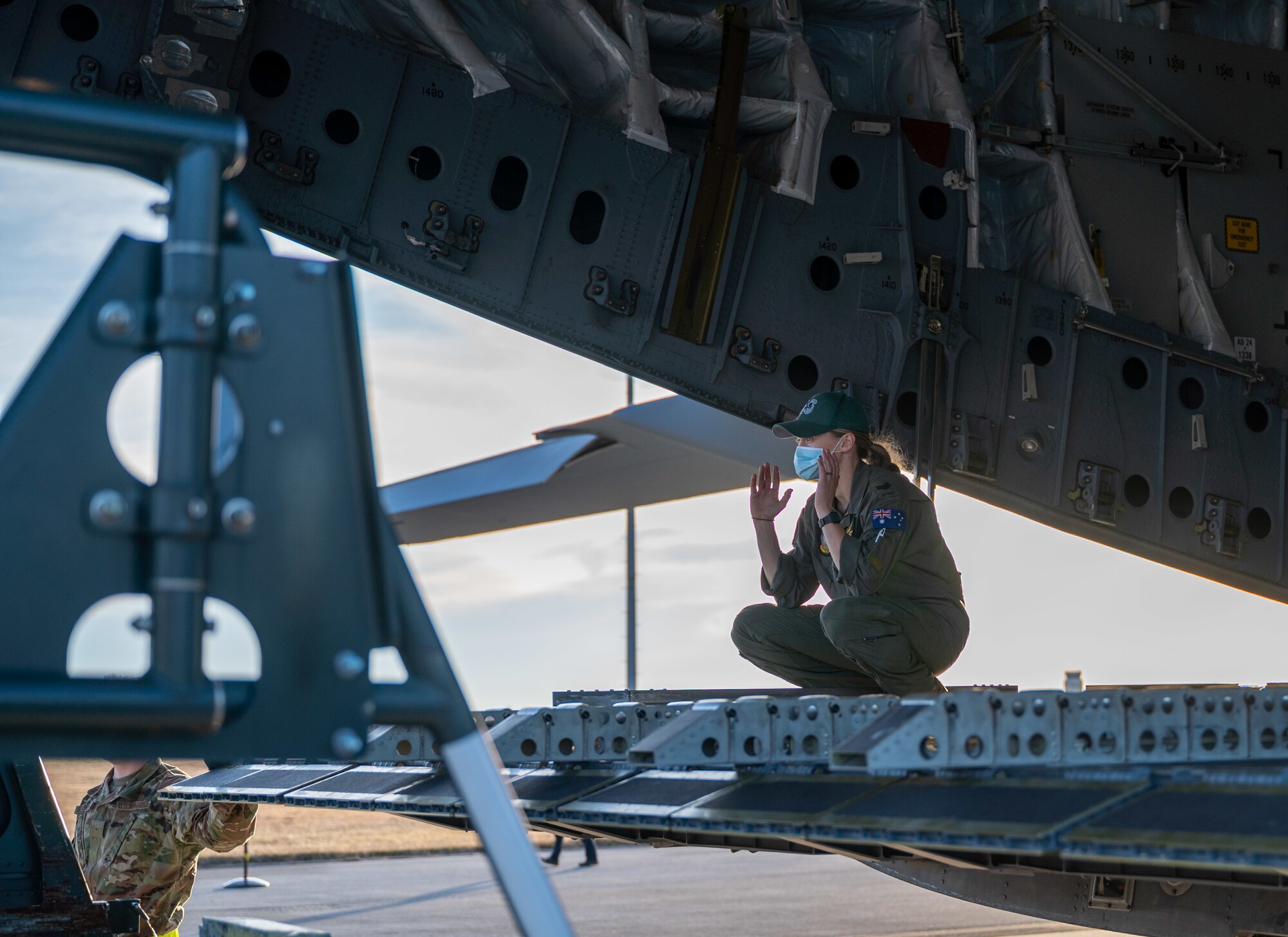 Sgt. Madison Cave-Freeman, Royal Australian Air Force 36th Squadron loadmaster, marshals a K-loader to the ramp of a RAAF C-17 Globemaster III at Dover Air Force Base, Delaware, March 13, 2021. The U.S. and Australia maintain a robust relationship underpinned by shared democratic values, common interests and cultural bonds. The U.S.-Australia alliance is an anchor for peace and stability in the Indo-Pacific region and around the world. (U.S. Air Force photo by Airman 1st Class Faith Schaefer)