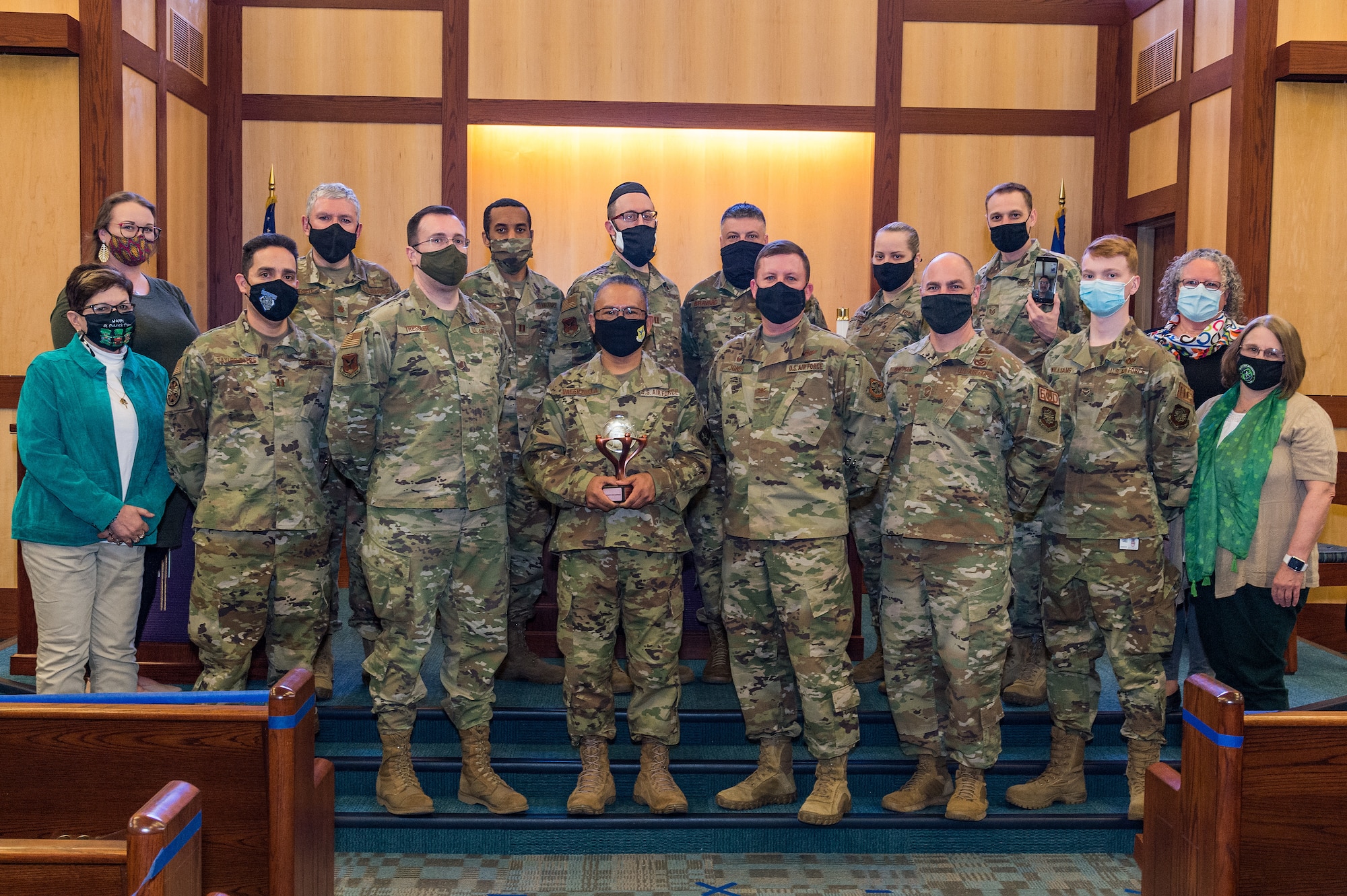 The 436th Airlift Wing chapel team is presented the Charles I. Carpenter Award by Col. Matthew Jones, 436th AW commander, at the base chapel on Dover Air Force Base, Delaware March 17, 2021. The chapel team was the recipient of Air Mobility Command’s Outstanding Large Chaplain Corps Team Award for 2020. Not pictured is Airman 1st Class Benito Reina, 436th AW Religious Affairs Airman, who was the recipient of AMC’s Outstanding Religious Affairs Airman Award. (U.S. Air Force photo by Roland Balik)