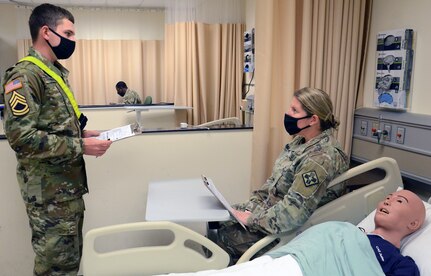 Army Pvt. Tobin Roche (left) conducts a simulated nutrition screening during a practical exercise in the Nutrition and Diet Therapy program at the Medical Education and Training Campus at Joint Base San Antonio-Fort Sam Houston.