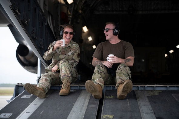 Woman and Man share take a water break on the ramp of a C-17 Globemaster