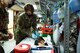 An Airmen draws blood from a patient.