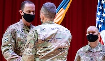 Lt. Gen. Daniel L. Karbler, Commander, U.S. Army Space and Missile Defense Command, passes the 1st Space Brigade guidon to incoming brigade commander Col. Donald K. Brooks during an assumption of command ceremony held at Fort Carson, CO March 5th, 2021. (U.S. Army photo by Staff Sgt. Dennis DePrisco)