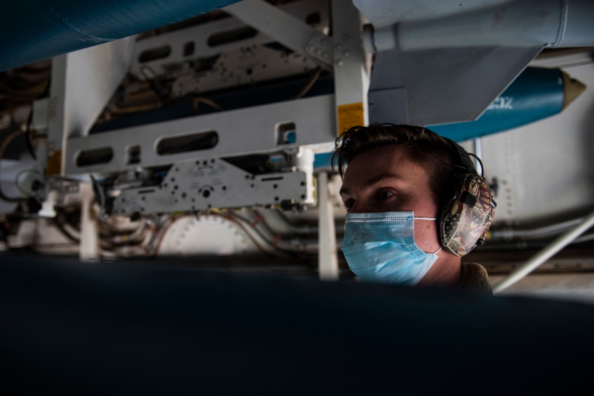 A weapons load crew team chief guides a dummy unit as it is lifted into the bomb-bay of a B-1B Lancer at Ørland Air Force Station, Norway, March 13, 2021. The B-1B carries the largest payload of both guided and unguided conventional weapons in the U.S. Air Force inventory. (U.S. Air Force photo by Airman 1st Class Colin Hollowell)