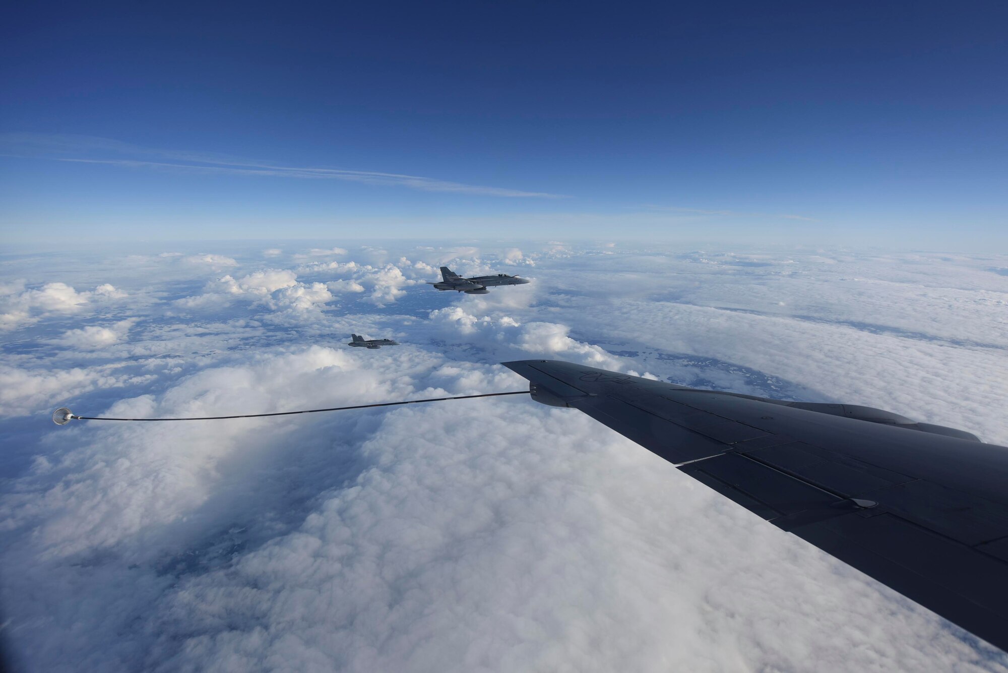 Two Finnish air force F-18 Hornet aircraft fly alongside a U.S. Air Force KC-135 Stratotanker aircraft assigned to the 100th Air Refueling Wing over Finland during exercise Baltic Trident, March 16, 2021. The complexity of the European continent and the tyranny of proximity makes operating with allies and partners throughout Europe an imperative. (U.S. Air Force photo by Senior Airman Joseph Barron)