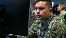 Staff Sgt. Yamil Ramirez-Lopez, a weapons operator with the 49th Missile Defense Battalion, Alaska Army National Guard, works in the Fire Direction Center at Fort Greely, Alaska. Soldiers from the 49th Missile Defense Battalion participated in Global Lightning 21, March 8-12, 2021. Team members of U.S. Army Space and Missile Defense Command and Joint Functional Component Command for Integrated Missile Defense supported U.S. Strategic Command and U.S. Space Command during the Global Lightning 21 annual battle staff exercise designed to train Department of Defense forces and assess joint operational readiness across mission areas. (U.S. Army photo by Staff Sgt. Zach Sheely)