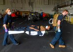 210210-N-GW139-1079
INDIAN OCEAN (February 10, 2021) Medical personnel carry a Sailor on a stretcher during Role 2 Light Maneuver (R2LM) medical training on board the Expeditionary Sea Base USS Hershel “Woody” Williams (ESB 4) in the Indian Ocean, Feb. 10, 2021. Hershel Williams is operating in U.S. Sixth Fleet to conduct interoperability training and building strategic partnerships with their African partners. (U.S. Navy photo by Mass Communication Specialist 2nd Class Eric Coffer/Released)