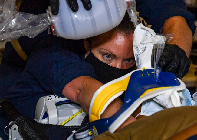 INDIAN OCEAN (February 10, 2021) Lt. Stacy Bourne simulates stabilizing a patient’s spine during a Role 2 Light Maneuver (R2LM) medical training on board the Expeditionary Sea Base USS Hershel “Woody” Williams (ESB 4) in the Indian Ocean, Feb. 10, 2021. Hershel Williams is operating in U.S. Sixth Fleet to conduct interoperability training and building strategic partnerships with their African partners.