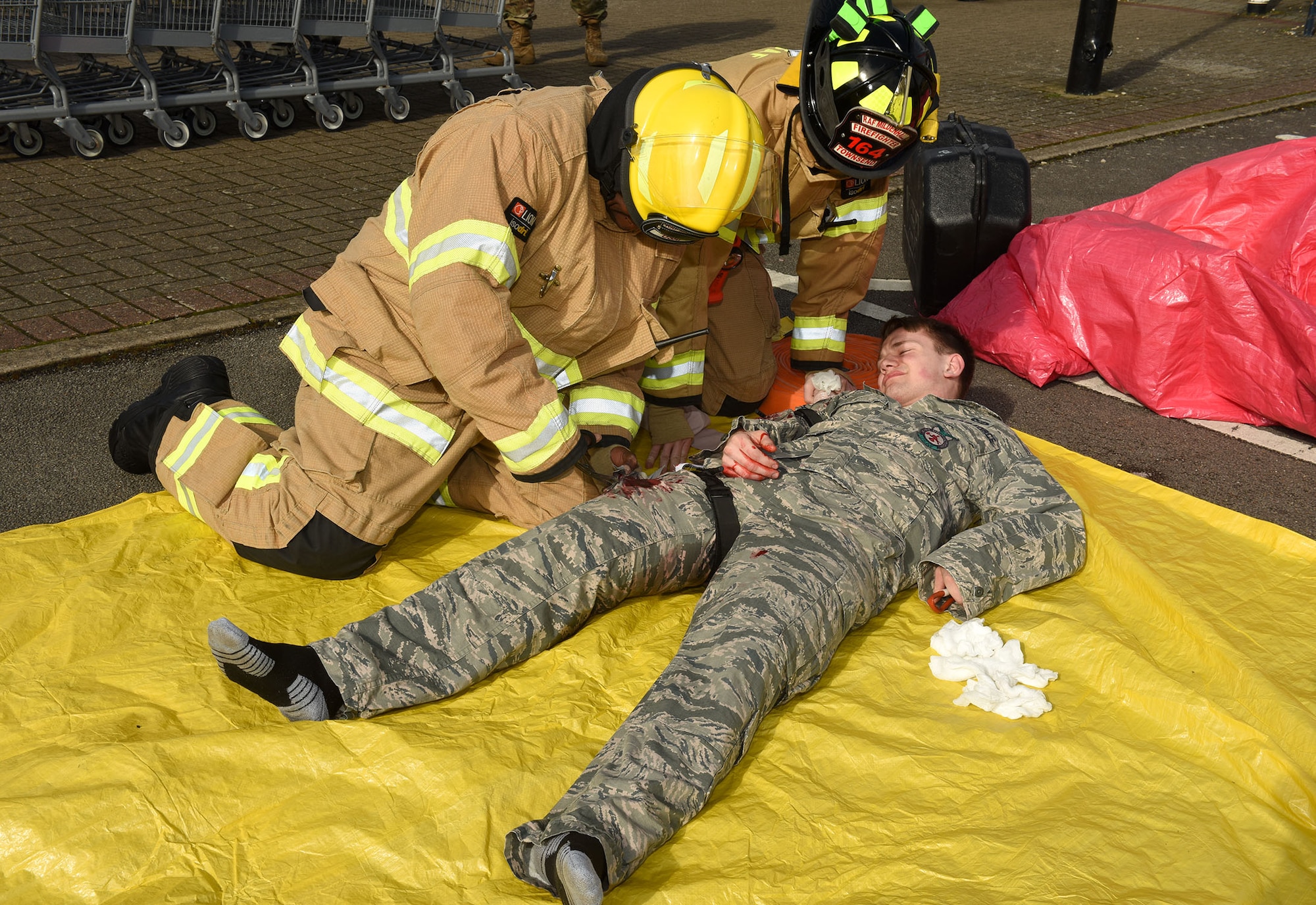 EXERCISE! EXERCISE! EXERCISE! Please do not be alarmed – all injuries are simulated and no Airmen were hurt in the making of this scenario.

Firefighters from the 100th Civil Engineer Squadron Fire Department triage a simulated gunshot victim during an active shooter exercise at Royal Air Force Mildenhall, England, March 17, 2021. Volunteers from the fire department role played as victims and were given moulaged injuries to provide realism for emergency responders. The scenario was one of many held throughout the week to test the readiness of emergency responders and base defense. (U.S. Air Force photo by Karen Abeyasekere)