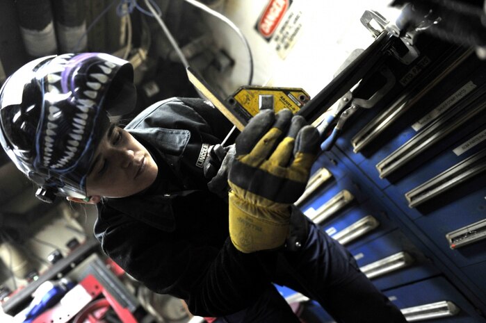 Coast Guard Petty Officer 2nd Class Alex Dey fabricates a hose rack while underway aboard Coast Guard Cutter Eagle in the Atlantic Ocean, Thursday, March 24, 2016. The Eagle hosts a full time crew who maintain the ship. U.S. Coast Guard photo by Petty Officer 2nd Class Matthew S. Masaschi.