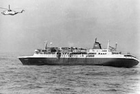 MS Prinsendam sinking with a USCG HH-3 flying above the wreck