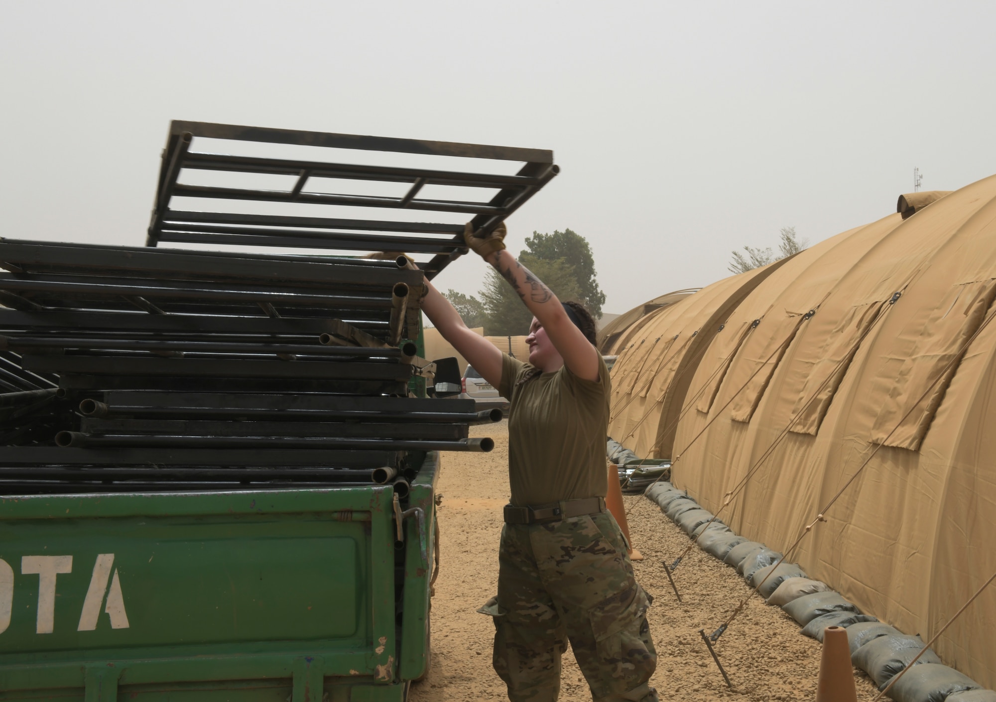 U.S. Air Force Senior Airman Madison Morgan, 768th Expeditionary Air Base Squadron Base Exchange manager, replaces broken bunk bed frames in preparation for a surge of new deployers at Nigerien Air Base 101, Niamey, Niger, Feb. 17, 2021. Bunk beds are replacing cots to improve the quality of life for transient members coming to Air Base 101. (U.S. Air Force photo by Senior Airman Gabrielle Winn)