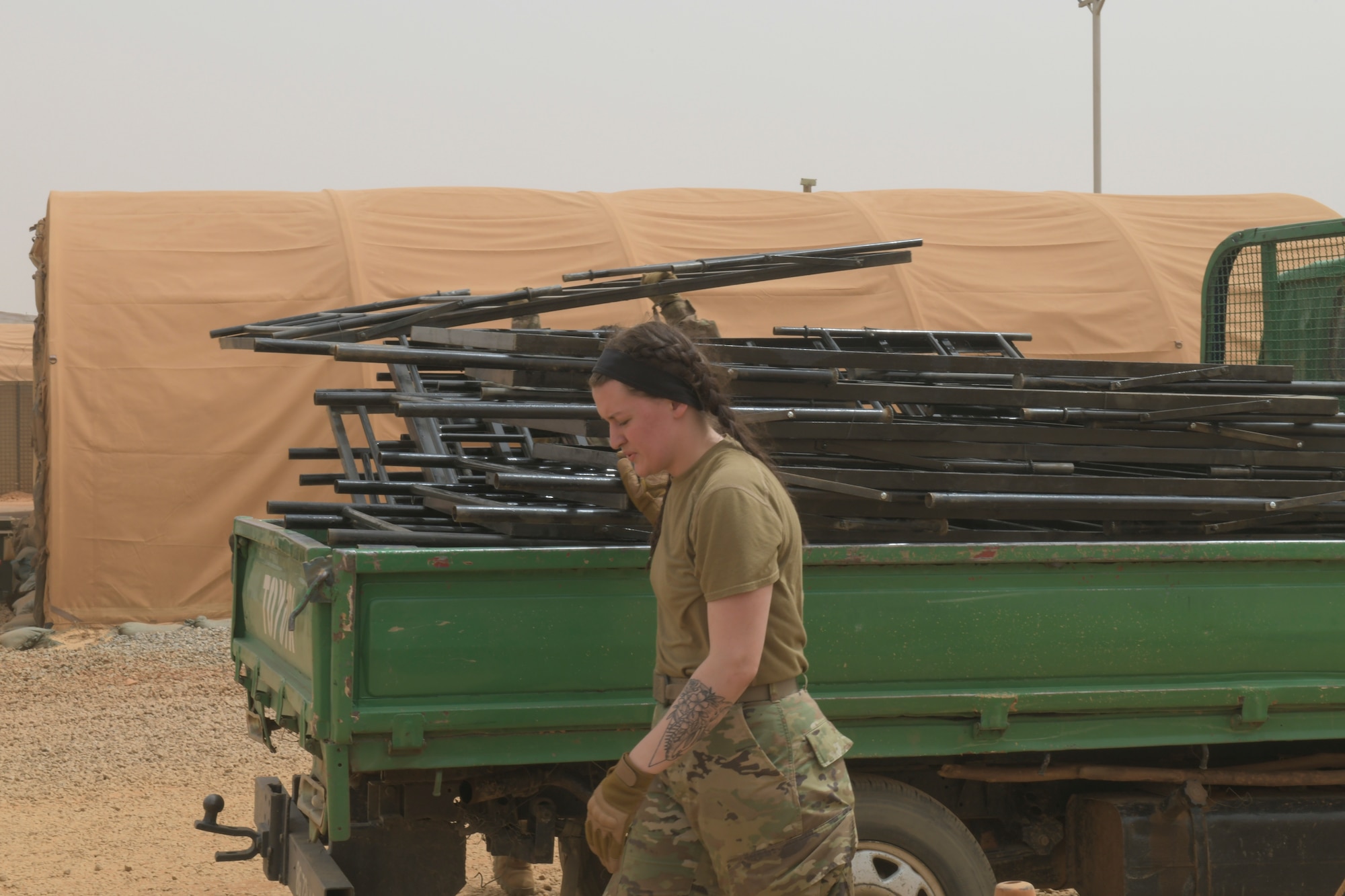 U.S. Air Force Senior Airman Madison Morgan, 768th Expeditionary Air Base Squadron Base Exchange manager, prepares to remove broken bunk bed frames from a transient tent at Nigerien Air Base 101, Niamey, Niger, Feb. 17, 2021. The base is constantly working to ensure deployed Airman have the best operating and living conditions possible. (U.S. Air Force photo by Senior Airman Gabrielle Winn)
