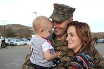 After a six-month deployment to Okinawa, Sgt. Christopher Lafriniere, a communications specialist with 3rd Battalion, 5th Marine Regiment, I Marine Expeditionary Force, greets his family at Marine Corps Base Camp Pendleton, Calif., Nov. 18, 2014. I MEF is continuously placing trained and equipped Marines in positions around the world, ready to respond to any emergency.