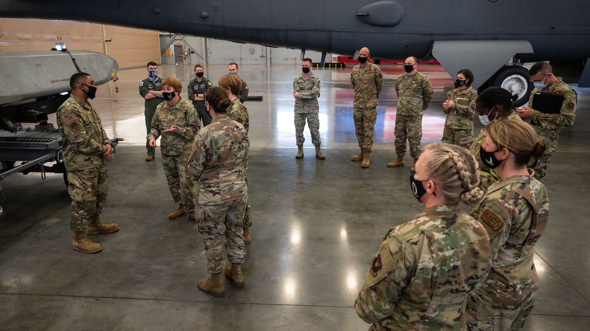 Lt. Gen. Dorothy Hogg, U.S. Air Force Surgeon General, middle left, and Chief Master Sgt. Dawn Kolczynski, Office of the Surgeon General medical enlisted force and enlisted corps chief, visit the 2nd Maintenance Group and speak with Airmen about their jobs and how they have handled the COVID-19 pandemic at Barksdale Air Force Base, Louisiana, March 10, 2021.