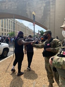 Members of the 372nd Military Police Battalion, District of Columbia Army National Guard, have positive interactions with protestors and other city pedestrians while assisting the D.C. Metropolitan Police Department at various metro stations June 6, 2020.