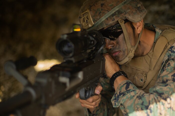 U.S. Marine Corps Lance Cpl. Joseph Lopez, a machine gunner with 3d Battalion, 8th Marine Regiment, 3d Marine Division, examines his sector of fire during Castaway 21.1 at Ie Shima, Okinawa, Japan March 13, 2021. The exercise demonstrated the Marine Corps’ ability to integrate with the joint force to seize and defend key maritime terrain, provide low-signature sustainment, and execute long-range precision fires in support of naval operations from an expeditionary advanced base. Lopez is a native of Long Island, New York.