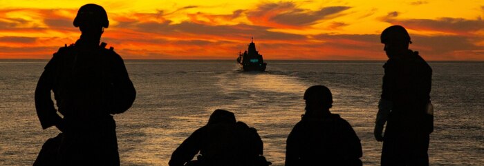 U.S. Marines and Sailors aboard the Wasp-class amphibious assault ship USS Essex (LHD-2) post security from the flight deck during exercise Steel Knight/Dawn Blitz (SK/DB) 21 off the coast of Southern California, Dec. 4, 2020. SK/DB 21 demonstrates 1st Marine Division’s and Expeditionary Strike Group’s (ESG) ability to employ the Corps’ largest Marine division, alongside our Navy counterparts, against a capable, peer or near-peer adversary. (U.S. Marine Corps photo by Lance Cpl. Cameron Rowe)