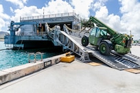 abees assigned to Naval Mobile Construction Battalion (NMCB) 4 load civil engineer support equipment (CESE) aboard the Spearhead-class expeditionary fast transport ship USNS Fall River (T-EPF-4) during a mount-out exercise (MOX) on board Naval Base Guam.
