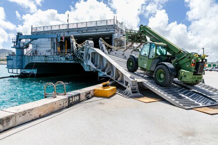 abees assigned to Naval Mobile Construction Battalion (NMCB) 4 load civil engineer support equipment (CESE) aboard the Spearhead-class expeditionary fast transport ship USNS Fall River (T-EPF-4) during a mount-out exercise (MOX) on board Naval Base Guam.