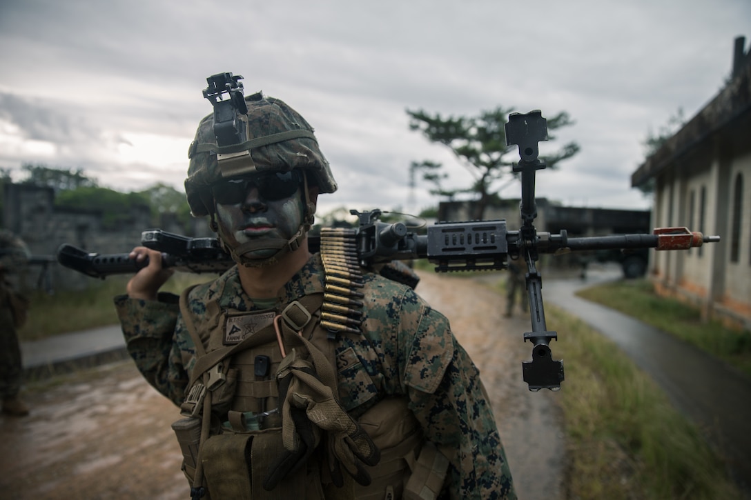 Lance Cpl. Gentrie Fanini, a machine gunner with Alpha Company, Battle Landing Team, 1st Battalion, 5th Marines, 31st Marine Expeditionary Unit, stands in a column formation at the Central Training Area, Okinawa, Japan, on Dec. 11, 2019. The 31st MEU is currently preparing for deployment through MEUEX, a two-week evolution that prepares the Marine Air-Ground Task Force for amphibious operations launched from naval vessels. The 31st MEU, the Marine Corps' only continuously forward-deployed MEU, provides a flexible and lethal force ready to perform a wide range of military operations as the premier crisis response force in the Indo-Pacific region. (Official U.S. Marine Corps photo by Lance Cpl. Andrew R. Bray)