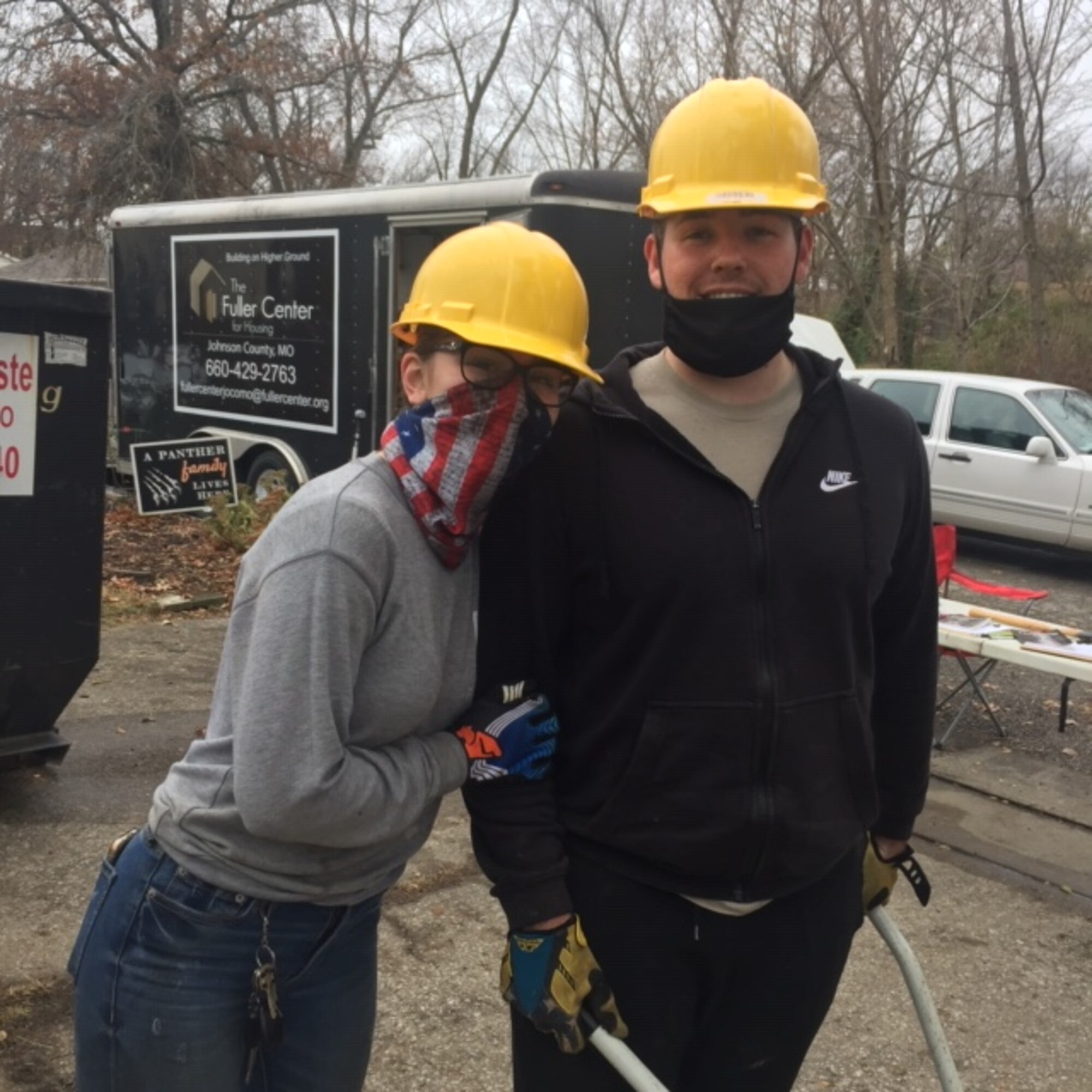 U.S. Air Force Airman 1st Class Naomi Aviles, and her husband stand for a photo wearing hard hats at the work site.