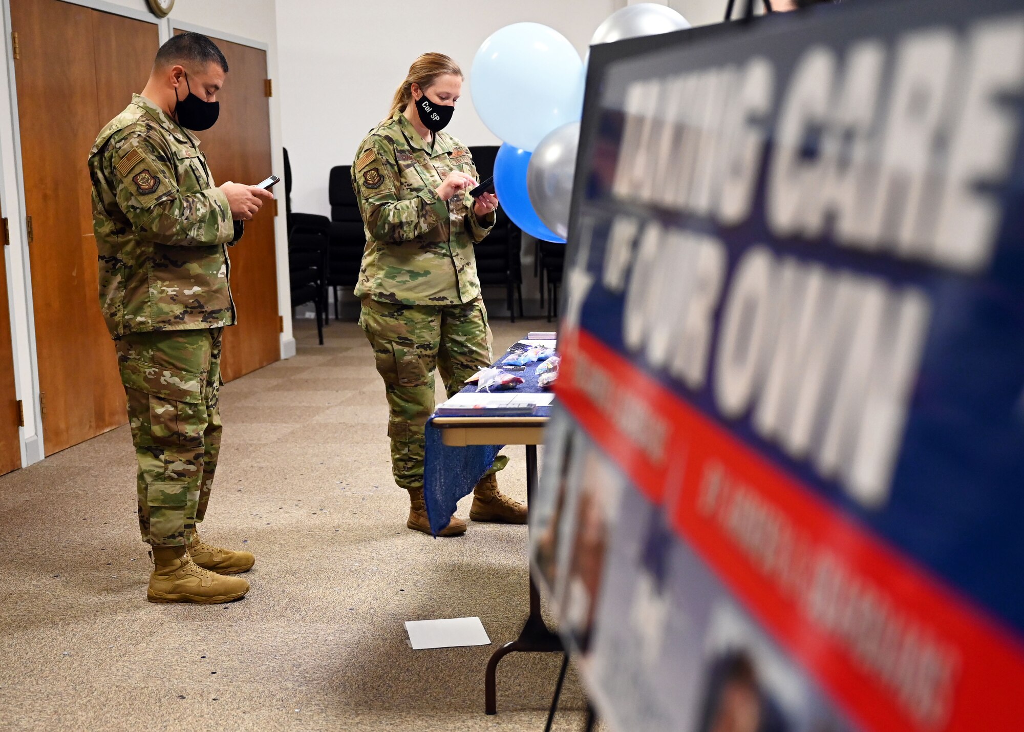 U.S. Air Force Chief Master Sgt. Joseph Arce, 62nd Airlift Wing command chief, and U.S. Air Force Col. Erin Staine-Pyne, 62nd AW commander, use their phones to donate to Air Force Assistance Fund at Joint Base Lewis-McChord, Washington, March 15, 2021. Currently, there are three ways to donate. The first and preferred method is through e-giving. To donate electronically, donors can text “AFAF” to 50155 or visit https://secure.qgiv.com/event/afaf/team/873061/. People can also donate by payroll deduction plans and through cash or check. (U.S. Air Force photo by Tech. Sgt. Joshua Smoot)