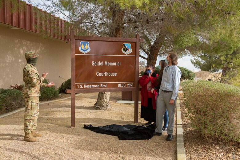 Col. Randel Gordon, 412th Test Wing Vice Commander, and the family of Warren Seidel, unveil the newly renamed "Seidel Memorial Courthouse" on Edwards Air Force Base, California, March 18. (Air Force photo by Richard Gonzales)