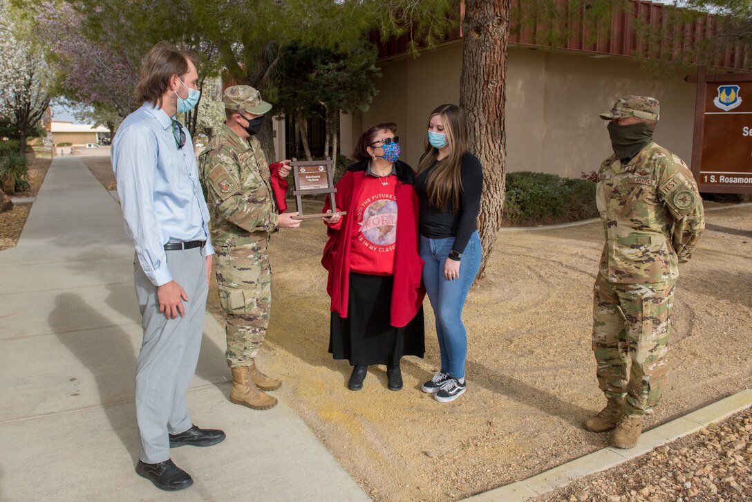 Lt. Col. James Lisher, 412th Test Wing Staff Judge Advocate, presents a replica of the newly-renamed "Seidel Memorial Courthouse" sign to Nadine Seidel, wife of the late Warren Seidel, at Edwards Air Force Base, California, March 18. Seidel passed away last year following a short battle with cancer, he had served at Edwards for almost 25 years. (Air Force photo by Richard Gonzales)