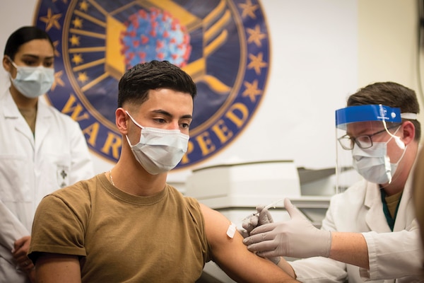 Navy Seaman Ezequiel Vega receives the COVID-19 vaccine at Walter Reed National Military Medical Center in Bethesda,
Md, as part of Operation Warp Speed. (December 21, 2020 Navy Petty Officer 1st Class Sarah Villegas)