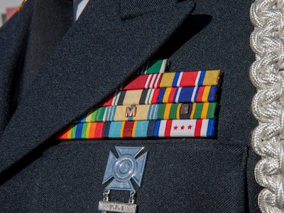 Military awards worn by a District of Columbia Army National Guard Soldier in Washington, D.C., March 10, 2021 include the D.C. National Guard Presidential Inauguration Support Ribbon on the bottom right. The ribbon is authorized for award to National Guard members from any state, territory or the District of Columbia who served in support of the 59th Presidential Inauguration on Title 32 orders. The National Guard has been requested to continue supporting federal law enforcement agencies with security, communications, medical evacuation, logistics and safety support to district, state, and federal agencies. (U.S. Army National Guard photo by Staff Sgt. Andrew Enriquez)