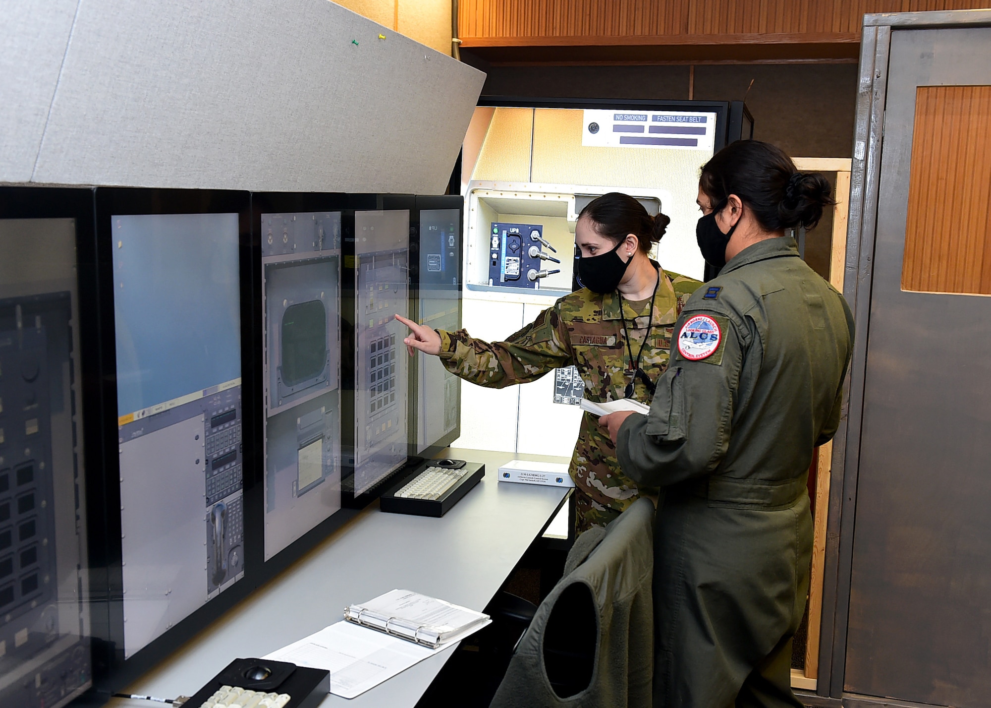 From left, Capt. Grazia Castagna, 625th Strategic Operations Squadron intelligence officer, and Capt. Stephanie Konvalin, 625th STOS strike planner, conduct operations in a newly-established trainer March 5, 2021, at Offutt Air Force Base, Neb.