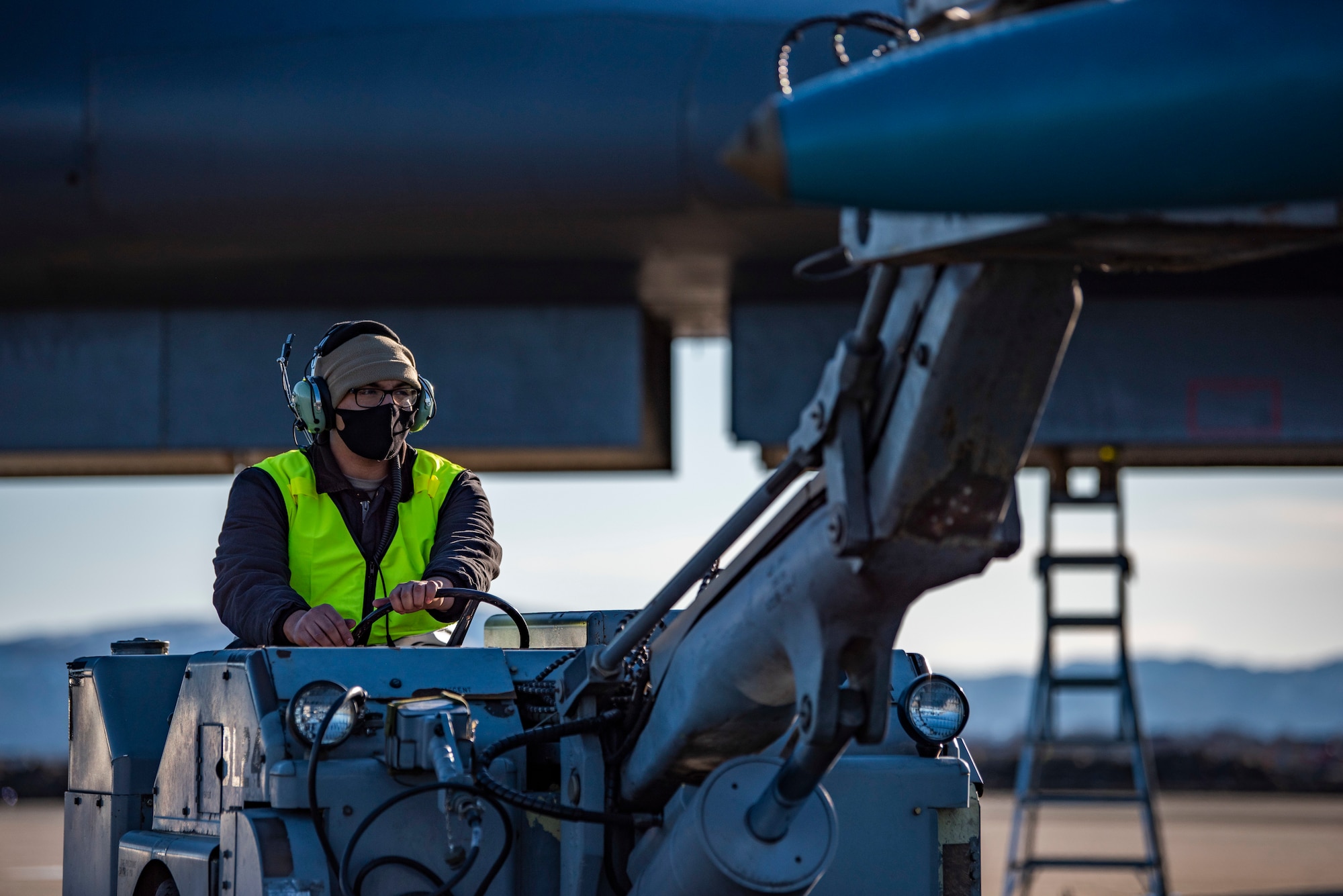 A weapons load crew member assigned to the 9th Expeditionary Bomb Squadron operates a MHU-83 jammer carrying a bomb dummy unit at Ørland Air Force Station, Norway, March 13, 2021. The jammer is capable of safely transporting and loading a variety of munitions. (U.S. Air Force photo by Airman 1st Class Colin Hollowell)