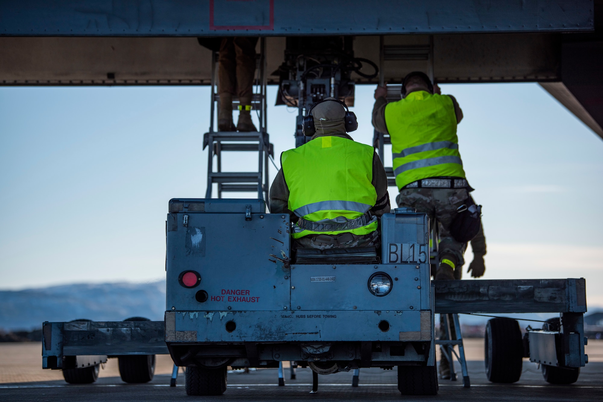 Weapons load crew members assigned to the 9th Expeditionary Bomb Squadron guide a bomb dummy unit into the bomb bay of a B-1B Lancer at Ørland Air Force Station, Norway, March 13, 2021. During Bomber Task Force training missions, aircrew routinely practices a variety of simulated air strikes using BDUs. (U.S. Air Force photo by Airman 1st Class Colin Hollowell)