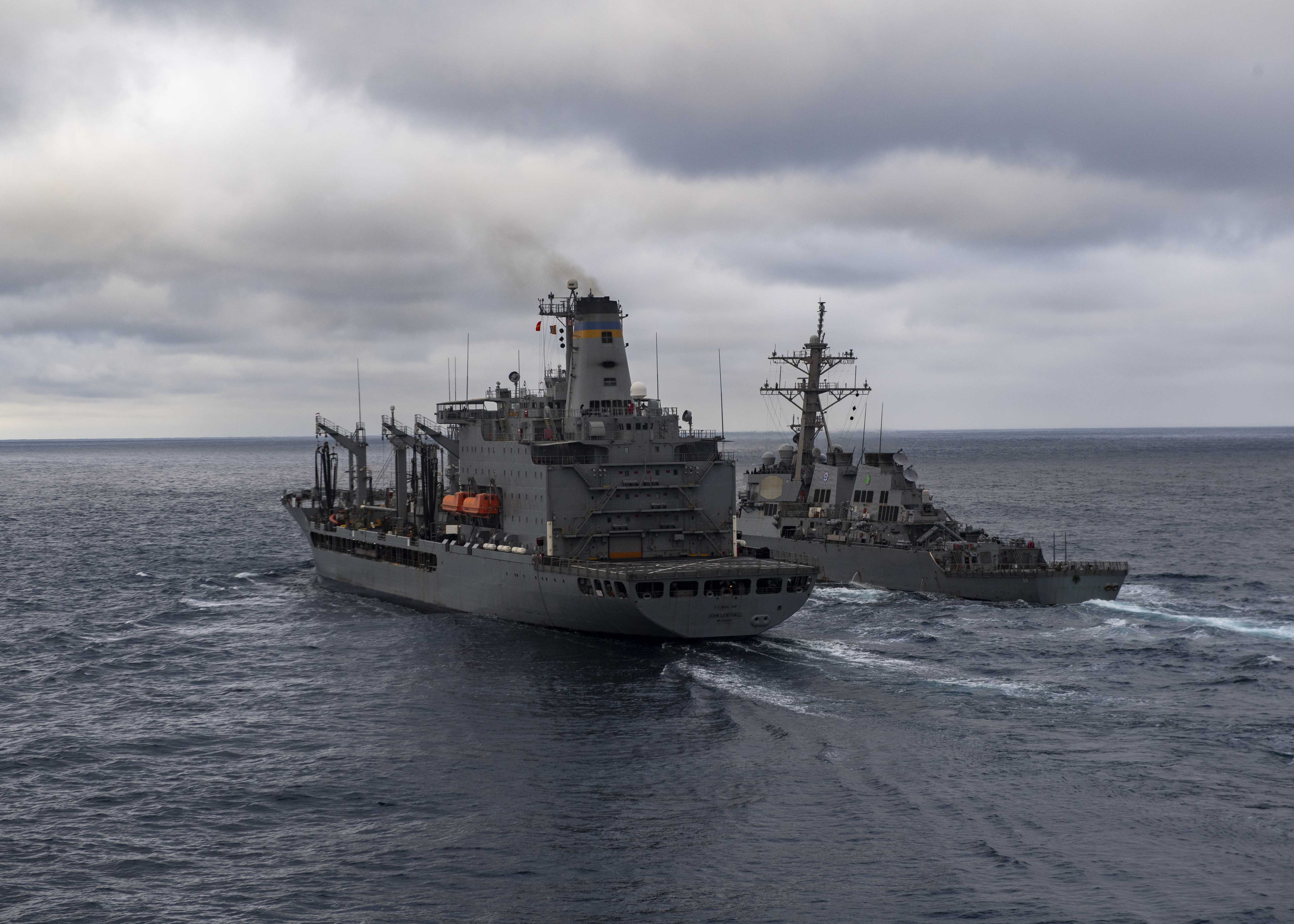 USS Carter Hall (LSD 50), not pictured, approaches  USNS Lenthall (T-AO 189), left, and the Arleigh Burke-class guided-missile destroyer USS The Sullivans (DDG 68) during a replenishment-at-sea, March 17, 2021.