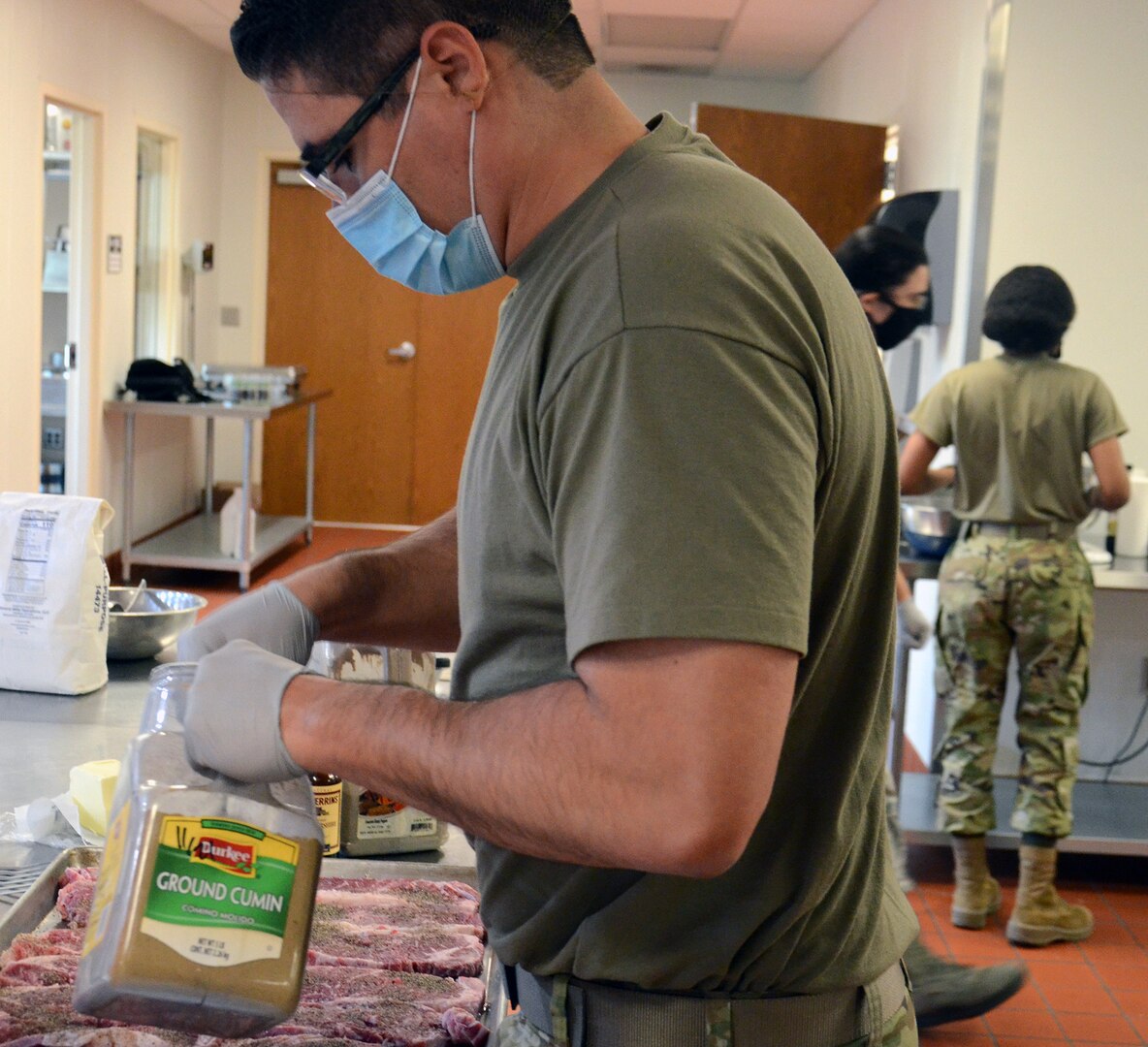 Master Sgt. Jorge Nikolas, an Air Force student in the Nutrition and Diet Therapy program at the Medical Education and Training Campus at Joint Base San Antonio-Fort Sam Houston, prepares a tray of steaks in the kitchen training laboratory.